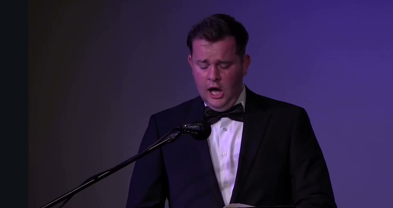 Royal Grubbs singing a tenor solo in formal dress